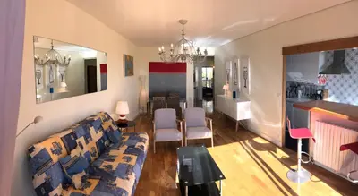 a living room with a couch and a dining room at **** Panoramic Top Roof in Beaulieu **** in Beaulieu-sur-Mer