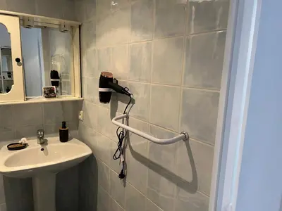 a bathroom with a sink and a mirror and a shower at Luxe et charme Méditerranéen face à la promenade des Anglais in Nice