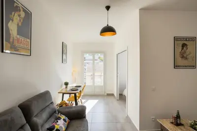 a living room with a couch and a table at Chic appartement Centre NICE au calme vue colline in Nice