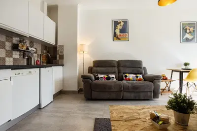 a living room with a couch and a table at Chic appartement Centre NICE au calme vue colline in Nice
