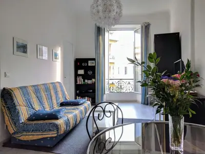 a living room with a couch and a glass table at Anderson apartment in Nice