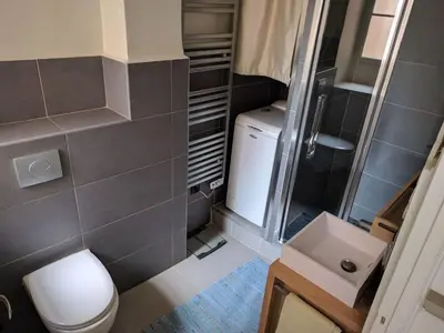 a small bathroom with a toilet and a sink at Anderson apartment in Nice