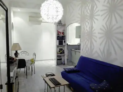 a living room with a blue couch and a table at Anderson apartment in Nice