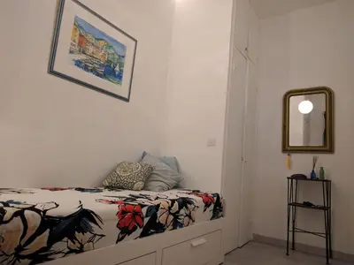 a bedroom with a bed and a mirror on the wall at Anderson apartment in Nice