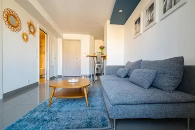a living room with a blue couch and a table at La Maioneta Carré d'Or in Nice