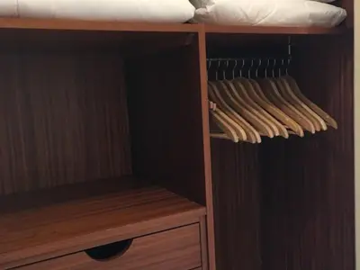 a wooden closet with wooden shelves and a bed at Belle Epoque Studio in Nice