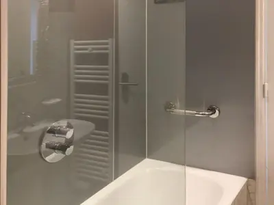 a bathroom with a glass shower with a sink at Belle Epoque Studio in Nice
