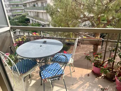 a balcony with a table and chairs on a patio at Studio Nice colline avec parking privé in Nice