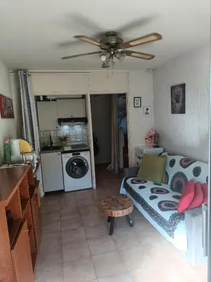 a living room with a bed and a ceiling fan at Studio Nice colline avec parking privé in Nice