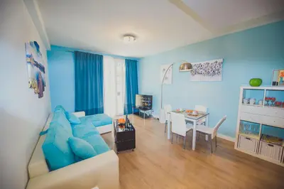 a blue living room with a blue couch and a table at AzurAppart 3room Nice Promenade in Nice