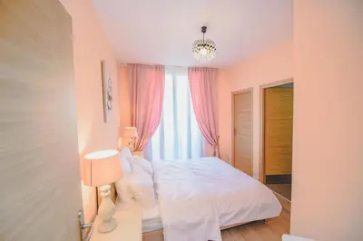 a bedroom with a white bed and a window at AzurAppart 3room Nice Promenade in Nice