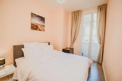 a bedroom with a white bed and a window at AzurAppart 3room Nice Promenade in Nice