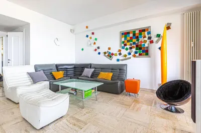 a living room with a couch and a table at Appartement Eze bord de mer in Èze