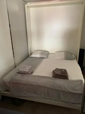 a bed in a room with two towels on it at Appartement Eze bord de mer in Èze