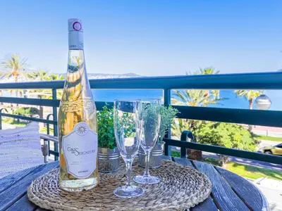 a bottle of wine and two glasses on a table at Studio La Joconde by Interhome in Nice