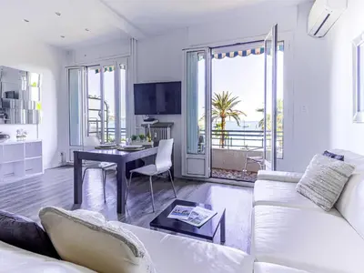 a living room with a white couch and a table at Studio La Joconde by Interhome in Nice