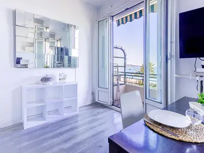 a white room with a table and a large window at Studio La Joconde by Interhome in Nice