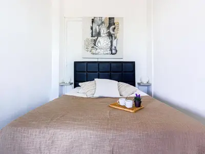 a bedroom with a large bed with two mugs on it at Studio La Joconde by Interhome in Nice