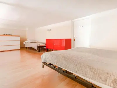 a bedroom with a bed and a red dresser at Apartment Le Masséna by Interhome in Nice