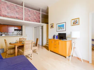 a living room with a table and a dining room at Apartment Le Masséna by Interhome in Nice