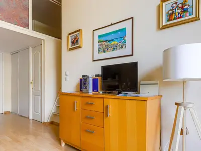 a living room with a tv on a wooden dresser at Apartment Le Masséna by Interhome in Nice