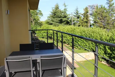 a table and chairs on the balcony of a house at Les Bastides D'Hélène in Èze