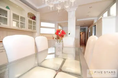 a dining room with white chairs and a glass table at Le Majestic Promenade - Five Stars Holiday House in Nice