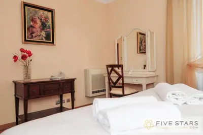 a bedroom with a bed and a desk and a mirror at Le Majestic Promenade - Five Stars Holiday House in Nice