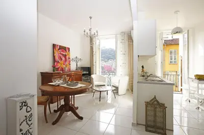 a kitchen and a dining room with a table and a kitchen at AIGUE-MARINE - Superbe appartement Vue Mer 4 personnes au Port de Nice in Nice