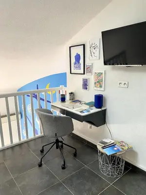 a desk with a chair and a television in a room at TOBIAS - Appartement Duplex 4 personnes Quartier Riquier Nice in Nice