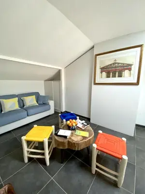 a living room with a couch and a table and chairs at TOBIAS - Appartement Duplex 4 personnes Quartier Riquier Nice in Nice