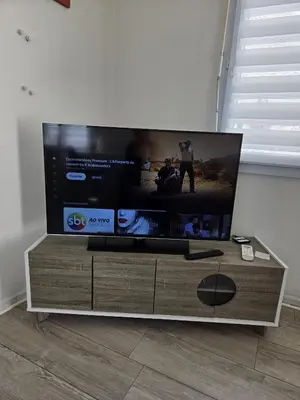 a large flat screen tv sitting on a entertainment center at Plein centre Appartement climatisé et spacieux avec grande terrasse sur le toit à Nice in Nice