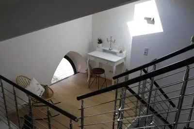 a staircase leading to a room with a table and chairs at Luxueux 3 Pièces - Wilson in Nice