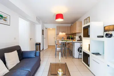 a living room with a couch and a kitchen at VICTOR HUGO AP4159 Nice, by Riviera Holiday Homes in Nice
