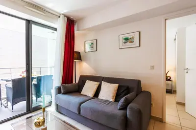 a living room with a couch and a large window at VICTOR HUGO AP4159 Nice, by Riviera Holiday Homes in Nice