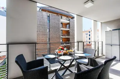 a balcony with a table and chairs and a large window at VICTOR HUGO AP4159 Nice, by Riviera Holiday Homes in Nice