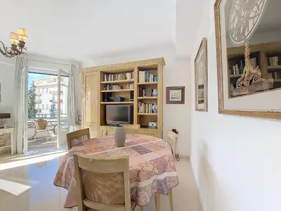 a dining room with a table with chairs and a television at Nestor&Jeeves - SUITE FLORA - Promenade des Anglais - Central in Nice