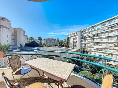 a patio with a table and chairs on a balcony at Nestor&Jeeves - SUITE FLORA - Promenade des Anglais - Central in Nice