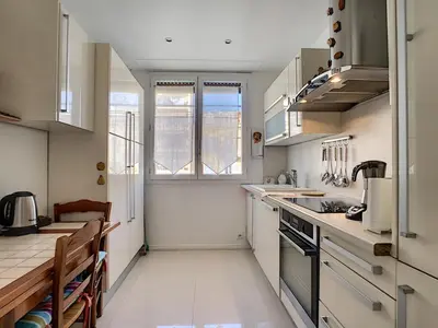 a kitchen with white cabinets and a counter top at Nestor&Jeeves - SUITE FLORA - Promenade des Anglais - Central in Nice