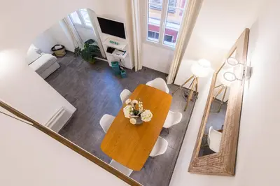 an overhead view of a table and chairs in a living room at Duplex in Rue de la Préfecture Old Town 2 Bdrs in Nice
