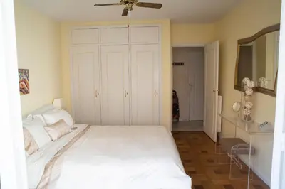a bedroom with a white bed and a ceiling fan at Chill Out Apartment, 2 mins from beach in Nice