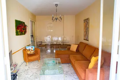 a living room with a couch and a table at Chill Out Apartment, 2 mins from beach in Nice