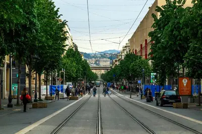 a city street with a train track in the middle at Nice Jean Médecin in Nice