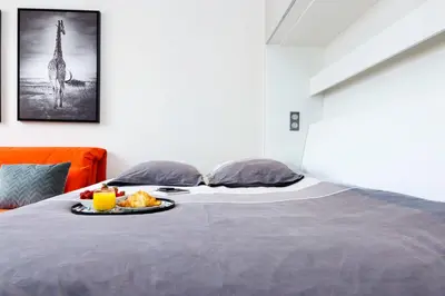 a bed with a tray of food on it at Nice Jean Médecin in Nice