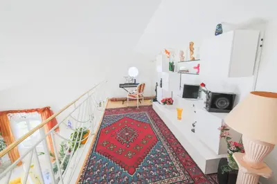 a white staircase with a red rug on the floor at LA CASETTA DEI FIORI VI3078 in Nice