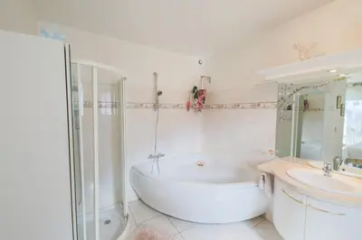 a white bathroom with a tub and a sink at LA CASETTA DEI FIORI VI3078 in Nice
