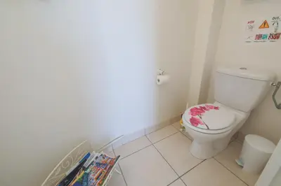 a bathroom with a toilet with a book on the floor at LA CASETTA DEI FIORI VI3078 in Nice