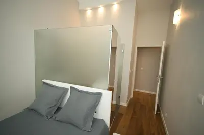a bedroom with a bed with two blue pillows at Old Town Luxury 3 Beds in Nice