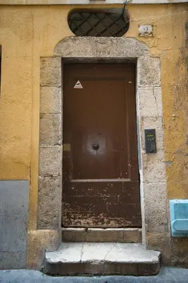 a brown door on a brick building with steps at Old Town Luxury 3 Beds in Nice