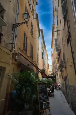 a narrow alley with buildings and a sign on a street at Old Town Luxury 3 Beds in Nice